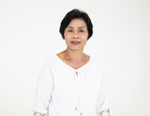 Portrait of good looking senior old woman wearing standing on white background.