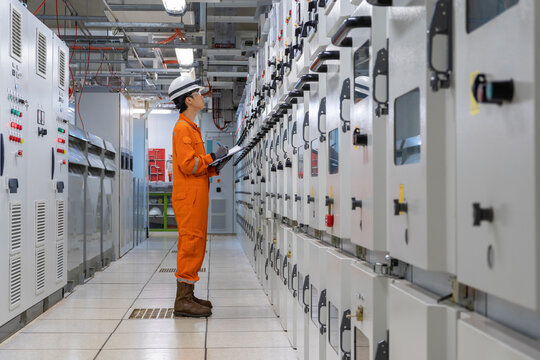 Electrician check and recording high voltage electrical switch board parameter at switch gear room for monitor power generation reliability of offshore oil and gas processing platform.