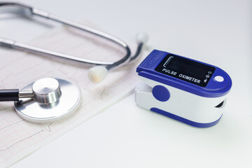 Medical concept. pulse oximeter, stethoscope and face masks. Selective focus