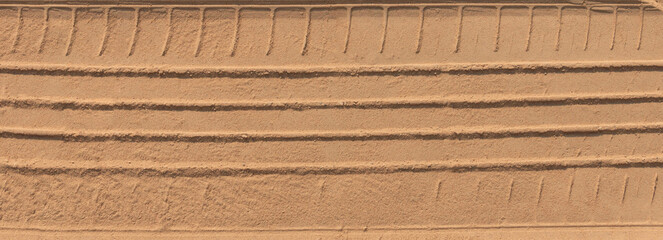 banner car tyre print on brown sand