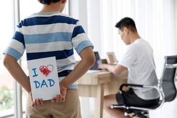 I love you, dad. Asian Happy family son Surprise, made a greeting card for Daddy on Father's Day. conecept.