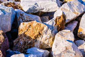 close up detail of rock surface with variety of colors under natural sunlight