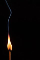 burning match on black background