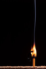 burning match on black background