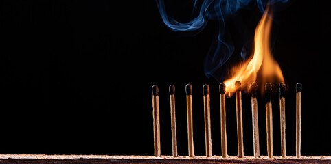 burning match on black background