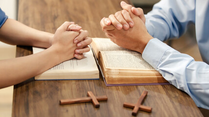 Close up hand. Christian women and men join hands in praying for Jesus' blessings to show love and...