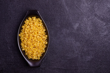 Dry pasta in a ceramic dish