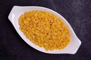 Dry pasta in a ceramic dish