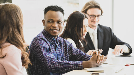 Fototapeta premium A man smilling african american In meetings about plans business at the meeting room in the office. Concept woman leader happy meeting.