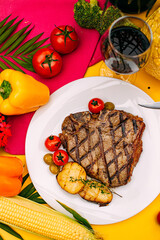 t-bone steak with grilled vegetables on a decorated table