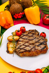 t-bone steak with grilled vegetables on a decorated table