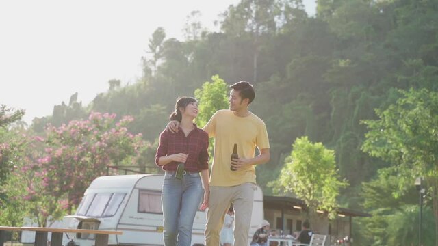 Lovely asian couple walking together on holiday trip with happiness.
