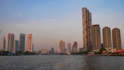 Fototapeta na wymiar January 2 2021 - Bangkok, Thailand : Beautiful Landscape of high modern building at Chaopraya River, Bangkok, Thailand