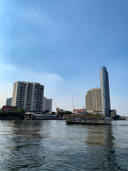 anuary 2 2021 - Bangkok, Thailand : Beautiful Landscape of high modern building and Ferry at Chao Praya River, Bangkok, Thailand