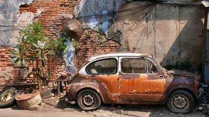 January 02 2021- Bangkok Thailand : Old  wrecked FIAT car with vintage brick ,the famous art wall...