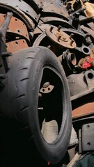 Fototapeta premium Old tire from used car at Second-hand spare parts of car store