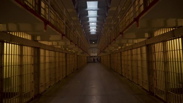 Inside Alcatraz prison, long row of cells. Concept of guilty, law or freedom