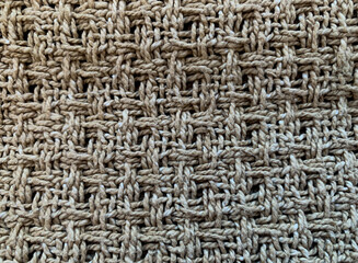 Brown background. The texture of a coarse fabric woven from a thick thread. Close-up