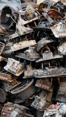 Pile of old machine parts in second hand machinery shop, background of damage and rusty old car machine