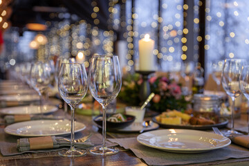 Modern veranda restaurant interior, banquet setting, glasses, plates