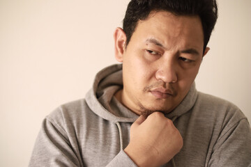 Fototapeta premium Sad depressed anxiety Asian man thinking contemplating bad thing happened in his life, stress exhausted feeling down expression, financial or relationship problem