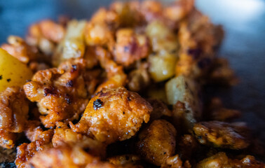 Close-up of spicy meat and small pineapple slices