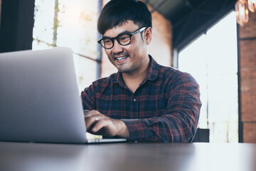 asian man work using computer hand typing laptop keyboard contact us.student study learning education online.adult professional people chatting search at office.concept for technology device business