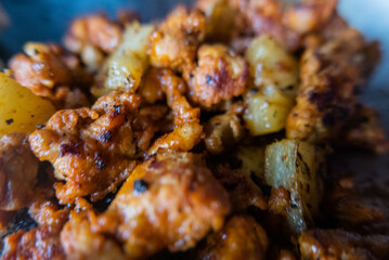 Close-up of spicy meat and small pineapple slices