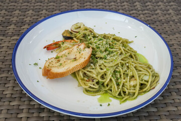 spaghetti with Presto sauce on white round dish