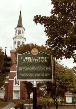 Burlington, Vermont - September 29th, 2019: Historical marker at entrance of Church Street Marketplace with First Unitarian Universalist Society church in the distance. 