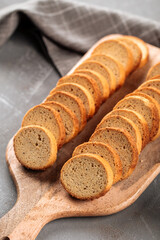 Closeup on dried bread croutons on the wooden cutting board