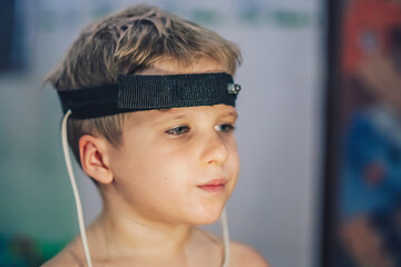 Express biofeedback microcurrent rezonans health of organs diagnostic. Sick child boy wear...