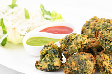 Authentic Indian Chaat Snacks Palak Pakoda Bhajji Chat Or Paalak Pakora Bajji Bhajiya Made Of Chopped Spinach Dhaniya Pudina Leaves And Gram Dal Flour Besan Masala Daal Served With Red Chutney Sauce