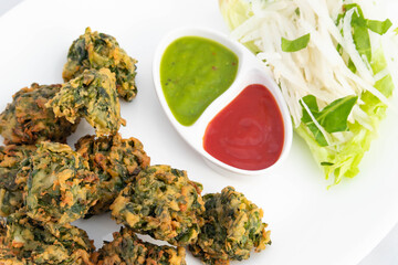 Authentic Indian Chaat Snacks Palak Pakoda Bhajji Chat Or Paalak Pakora Bajji Bhajiya Made Of Chopped Spinach Dhaniya Pudina Leaves And Gram Dal Flour Besan Masala Daal Served With Red Chutney Sauce