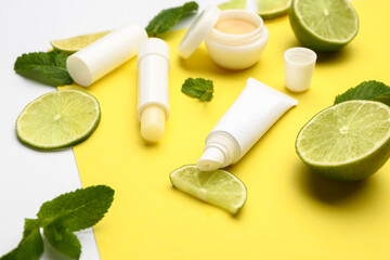 Fototapeta na wymiar Natural lip balms with lime on color background