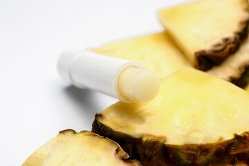 Natural lip balm with pineapple on white background