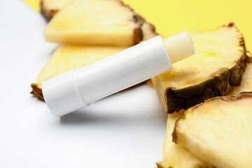 Natural lip balm with pineapple on white background