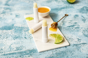 Natural lip balms with lime on color background