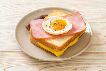 bread toasted cheese topped ham and fried egg with pork sausage