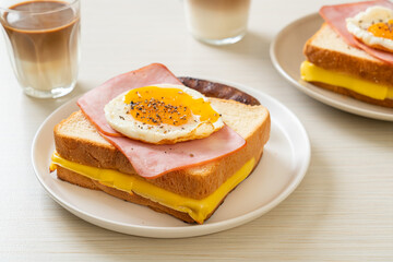 bread toasted cheese topped ham and fried egg with pork sausage