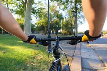 Male cyclist riding bicycle outdoors, closeup