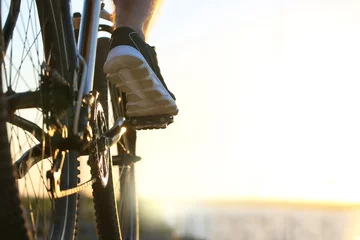 Rolgordijnen Male cyclist riding bicycle outdoors, closeup © Pixel-Shot