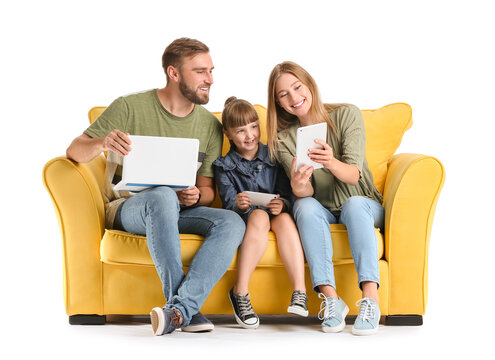 Happy family with gadgets on sofa against white background