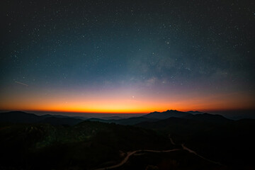 Naklejka na ściany i meble Panorama view universe space shot of milky way galaxy with stars on night sky background at mountains landscape Thailand