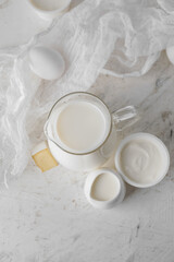 Different dairy products on light background