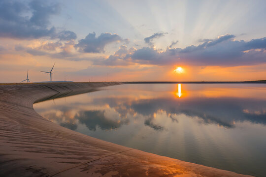 wind turbine generating electricity on dam catchment landscape energy transmission distribution equipment in natural environment