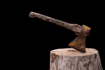 Old Axe stuck in a tree on a black background