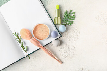 Composition with decorative cosmetics and notebook on table