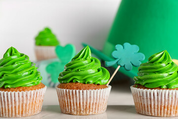 Tasty cupcakes for St. Patrick's Day on white background