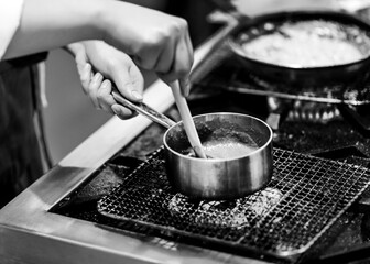 Chef cooking in a kitchen, chef at work, Black and White.